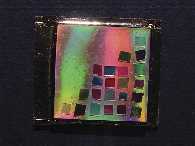 Figure 3. MIT’s Mathias Kolle developed a postage stamp-size chip that extends dark-field capabilities to conventional microscopes. The Bragg mirrors (small squares) generate various angular emission profiles. Courtesy of Cecile Chazot/MIT.