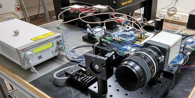 The camera, behind which is located the all-fiber dual-comb generator (right), in the second iteration of the direct hyperspectral dual-comb imaging system. Courtesy of University Carlos III de Madrid.