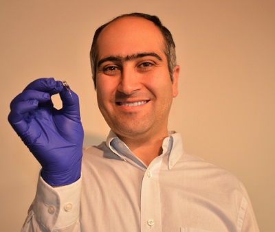 Maysam Chamanzar, associate professor of electrical and computer engineering at Carnegie Mellon University, holding his team's device. Courtesy of Carnegie Mellon University College of Engineering.