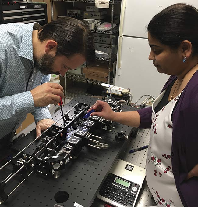 Giacomo Vacca (below left) and Kshitija Shevgaonkar of Kinetic River adjust a flow cytometer’s optics. With the emergence of improved optics and detectors, these instruments no longer need a lot of laser energy. Courtesy of Kinetic River Corp.