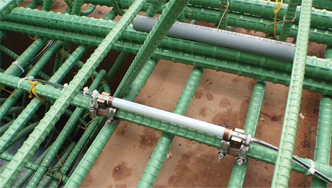 A fiber Bragg grating strain sensor is premounted on a reinforced concrete beam prior to the pouring of concrete. Upgrades to the aging transportation infrastructure in the U.S. could benefit from the inclusion of fiber sensors to monitor the health of bridges, tunnels, and other structures. Courtesy of MCH Engineering. Courtesy of MCH Engineering/Williams Inc.