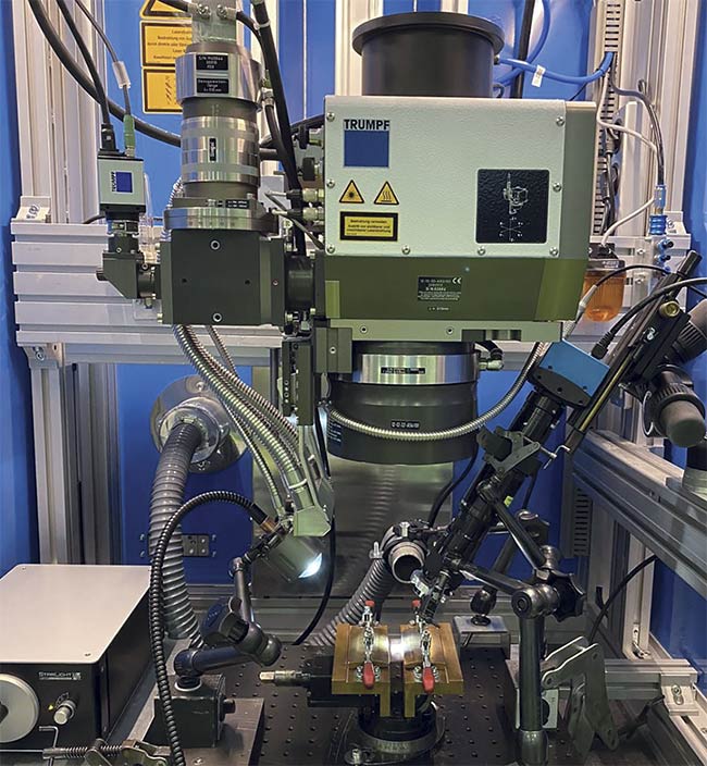 The experimental setup used to study copper laser welding. A laser enters from above, and a camera (right) captures images. Courtesy of Mikrotron and BLZ.