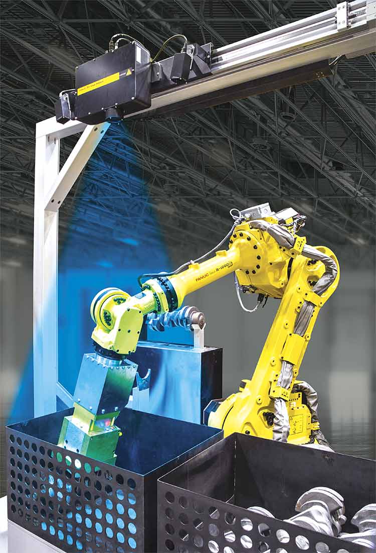 A robot arm picks random objects from a bin. A 3D camera sits above and shines structured light (blue) on the bin to help identify and locate objects to be picked. Courtesy of FANUC.