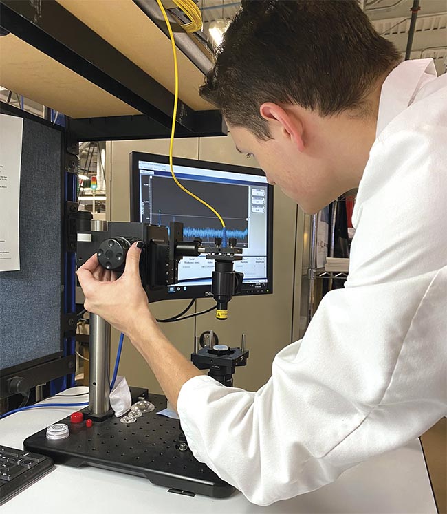 A student in SCCC’s Optics Technology associate degree program uses an interferometer-based optical thickness gauge to determine the size of an optic to submicrometer accuracy. Courtesy of Sussex County Community College.