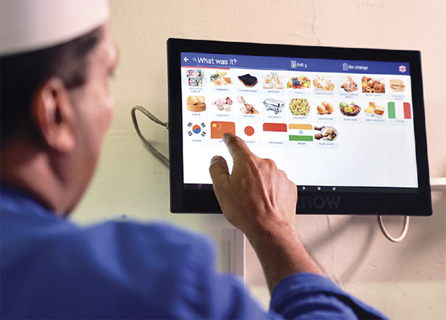 Kitchen staff use a touchscreen to make selections in the Winnow Vision food waste reduction system. Courtesy of Winnow.