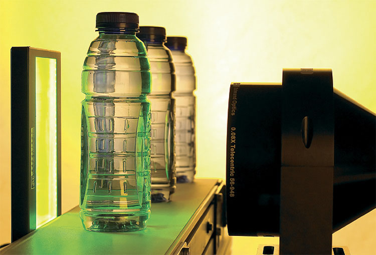 A telecentric lens and backlight illuminator used for bottle inspection. Courtesy of Edmund Optics.