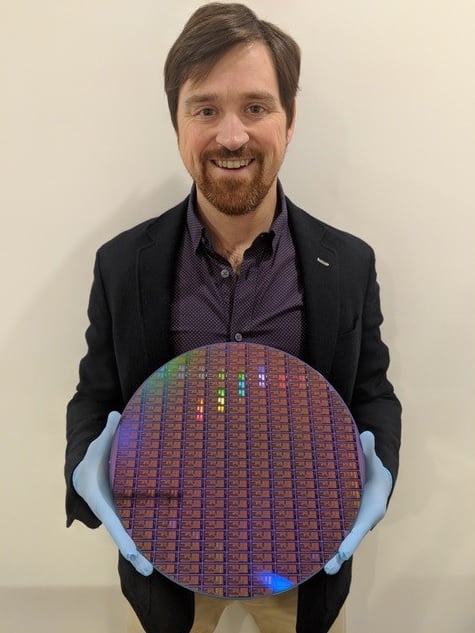 Dr. Chad Husko, CEO and founder of Iris Light, holds a 300 mm silicon wafer. Courtesy of Iris Light.