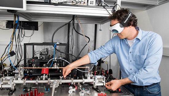 Coauthor Georg Winkler working on a setup used to characterize the high-performance mirrors under vacuum. Courtesy of Barbara Mair, Universität Wien.