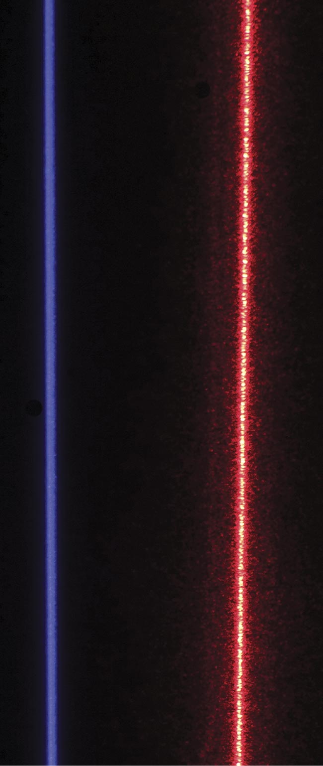 A blue, speckle-free laser and a red laser with speckle. The uniformity of the speckle-free line and the design of its associated optical elements leads to better accuracy, as well as resistance to occlusion and blocking for inverted installations. It also delivers more light to the target while being safer for human operators. Courtesy of Cognex Corp.