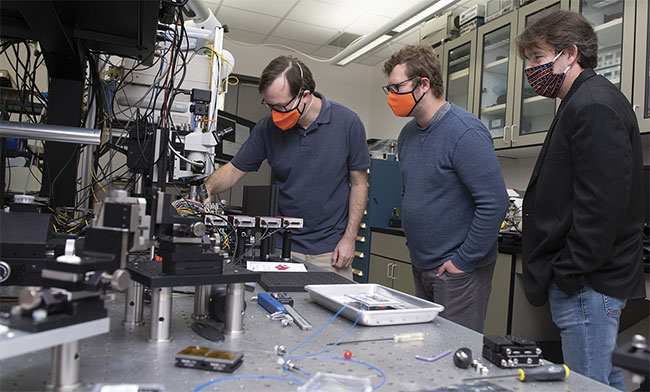 Informal coordination between industry and academia often leads to more structured partnerships. RIT researchers (from left) Stefan Preble, Gregory Howland, and Edwin Hach spent several years discussing possible projects in the area of quantum optics with scientists at L3Harris. In late 2020, RIT announced it was formalizing the arrangement in a partnership with the company to further advance the technology. Courtesy of A. Sue Weisler/Rochester Institute of Technology