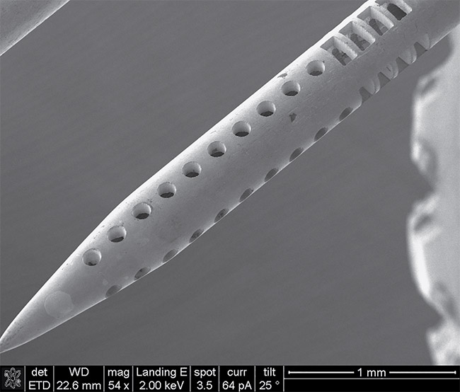 A scanning electron microscope image of laser micromachined features on a sample stainless steel injector. Courtesy of Amada Weld Tech.