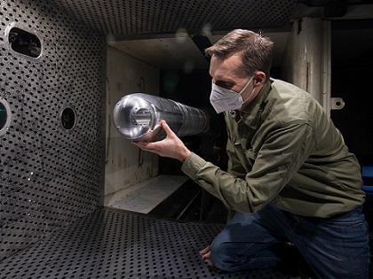 Dr. Rich Roberts, chief of the Aerodynamics Branch Store Separation Section of Arnold Engineering Development Complex, looks at a directed energy system turret positioned on a sting in the 4-foot transonic wind tunnel at Arnold Air Force Base, Tenn., March 5, 2021. Courtesy of Jill Picket, U.S. Air Force.