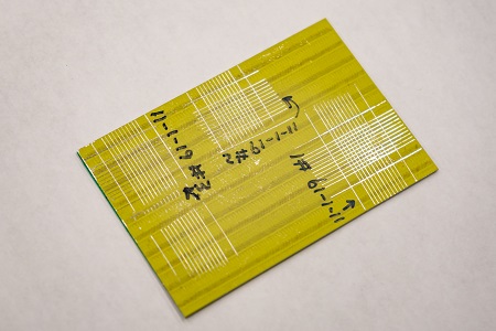 A primer-coated specimen shows marks from the laser system. Courtesy of Carlos Jones/ORNL, U.S. Department of Energy. After storing the aluminum samples in plastic cases for up to 70 days, the researchers spray-coated the samples with primers and topcoats that had been prepared using LIS, chromate conversion coating (CCC), and sulfuric acid anodizing (SAA) treatments. Courtesy of Carlos Jones/ORNL, U.S. Department of Energy.