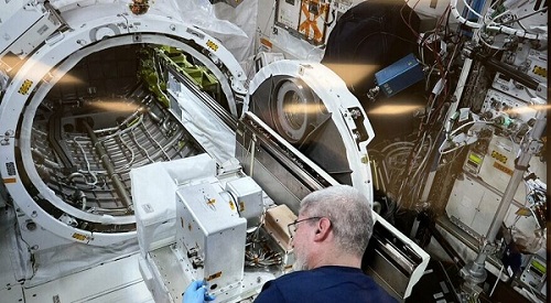 Astronaut on the International Space Station ISS assembling the components. Courtesy of NASA.