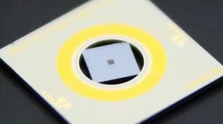 A research team has developed a metasurface lens that uses a piezoelectric think film to change focal length when a small voltage is applied. The work uses an architecture that features a suspended metasurface on a square silicon chip in a thin-film PZT Mems-actuated ring (yellow). Courtesy of SINTEF SMART Sensors and Microsystem/Christopher Dirdal.