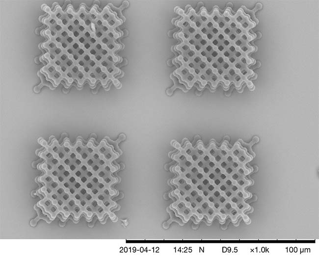 High-numerical-aperture optics focus a femtosecond laser beam into a tiny waist where the peak power of the ultrafast pulses is sufficient to drive two-photon absorption. The additive manufacturing technique delivers submicron spatial resolution and the creation of features as small as 100 nm. Courtesy of Wildman Lab/University of Nottingham.