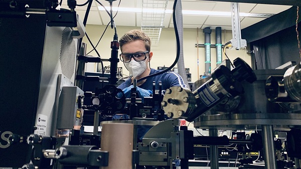Len van Deurzen works with a lab setup used to operate a deep-ultraviolet laser-emitting device. Van Deurzen led a team that developed a DUV semiconductor laser with a range of potential uses, such as in photolithography.  Courtesy of Cornell University.