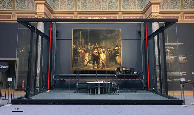 ‘The Night Watch’ is surrounded by a glass chamber in the Gallery of Honour at the Rijksmuseum in Amsterdam. The biggest research conservation project in the history of Rembrandt’s masterpiece uses a variety of photonic techniques, including hyperspectral imaging, performed in a specially designed glass chamber so that visitors can watch. See Reference 1. Courtesy of Rijksmuseum, Amsterdam.