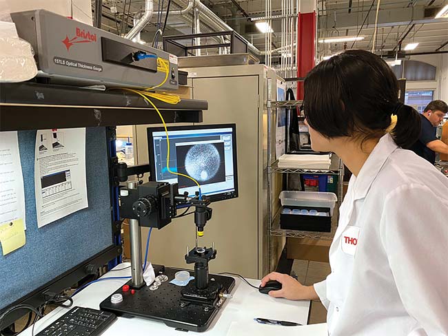 An SCCC student measures the thickness of an alignment window using a cutting-edge noncontact thickness gauge (below). Courtesy of Thorlabs.