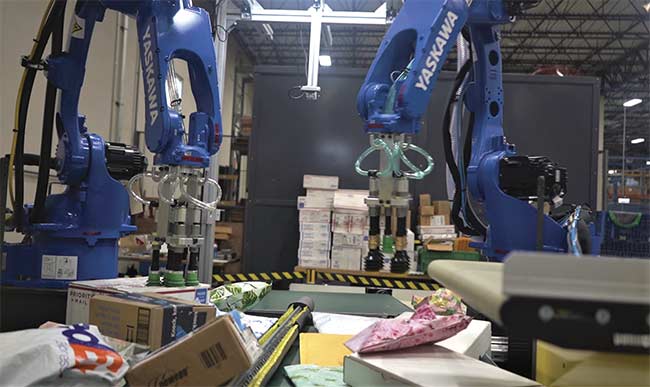The induction of goods into a warehouse often involves a convergence of items that vary in size, weight, shape, and texture. An imaging component allows a vision-guided robot to differentiate among the items. Courtesy of Yaskawa Motoman.
