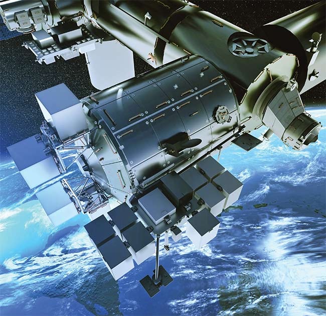 Figure 2. Europe’s Columbus module (center), part of the International Space Station, along with the Bartolomeo payload hosting platform. The OFC will operate from inside one of the boxes (bottom). Courtesy of Airbus.