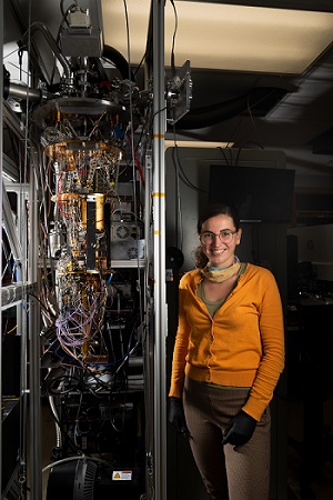 Ioana Craiciu, postdoctoral scholar at JPL and co-author of this study, next to a cryostat used for testing superconducting nanowire detectors. Courtesy of Ryan Lannom, JPL-Caltech/NASA.