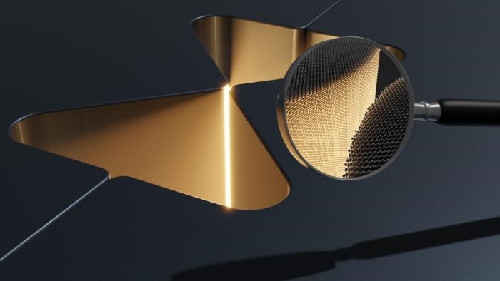 An illustration of the core of the photonic cavity that was fabricated as two halves that assembled themselves into one unit. The cavity confines light inside the gap, which is only a few atoms wide, as indicated in the field of view of the magnifying glass. Courtesy of Thor A. S. Weis.