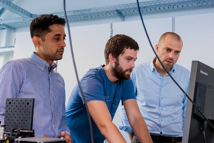 The leading authors at work in the lab. (l) to (r): Ph.D. student Ali Nawaz Babar, postdoc Guillermo Arregui, and associate professor Søren Stobbe. Courtesy of Ole Ekelund.