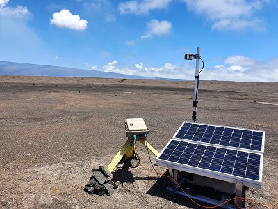 The SO2 camera installation on Kilauea volcano, Hawaii, US. The gas plume can be faintly seen rising from the crater at the center of the image and drifting to the left. The flank of Moana Loa can be seen in the background. Courtesy of Tom Pering.