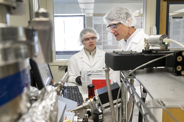 PhD student Jessica Peterson and Professor John Conley discussing the operation of one of his group’s atomic layer deposition (ALD) systems. Courtesy of Oregon State University.