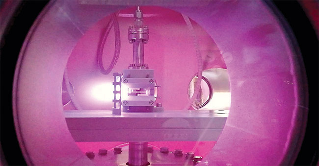View into a vacuum chamber with a centimeter-scale source of giga-electronvolt beams. The plasma is generated in the narrow channel in the center by a high voltage. Courtesy of DESY, Alexander Knetsch.