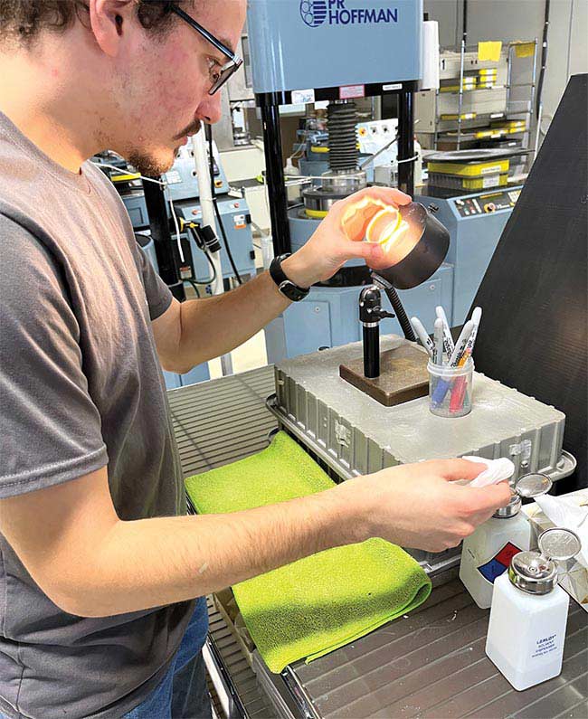 Optical technicians working at Sydor Optics. Sydor has helped maintain its optics manufacturing workforce by sponsoring apprenticeships since 2020. Courtesy of Sydor Optics.