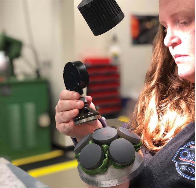 A Monroe Community College student handles a spherometer. Courtesy of Monroe Community College.