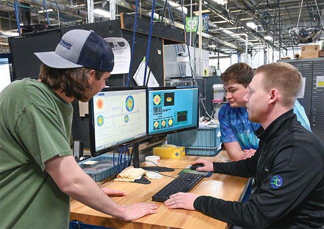 Precision optics manufacturing apprentices convene in a manufacturing cell at Optimax. Courtesy of Optimax.