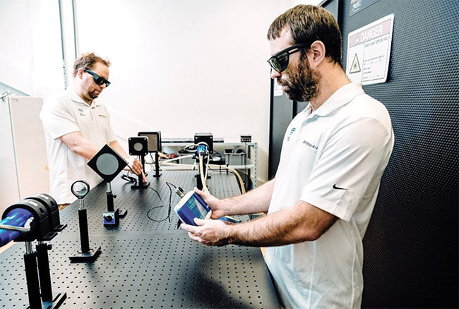 Technicians measure fiber laser power at Gentec-EO. Courtesy of Gentec-EO.