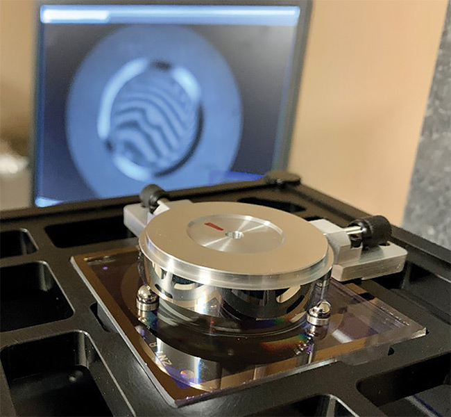 Computer-generated holograms (CGHs) combine with laser interferometry for the precision metrology of aspheres and freeform optical parts. Here, a freeform test mirror mounted and automatically aligned to a CGH enables fast measurements, high throughput, and precise results. Courtesy of Zygo Corporation and Arizona Edmund Optics Optical Metrology.