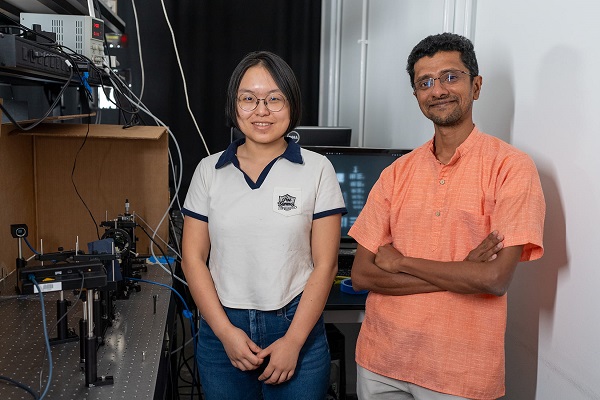 Rice University Ph.D. student Haiyun Guo and Prof. Ashok Veeraraghavan in the Rice Computational Imaging Laboratory. Guo, Veeraraghavan and collaborators at the University of Maryland have created full-motion video camera technology that corrects for light-scattering and has the potential to allow cameras to film through fog, smoke, driving rain, murky water, skin, bone and other light-penetrable obstructions. Courtesy of Brandon Martin/Rice University.