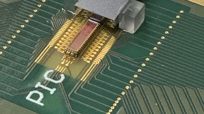 Photonic transmitter chip mounted on a printed circuit board with electrical and fiber optic connections. Courtesy of Lightwave Research Laboratory/Columbia Engineering.