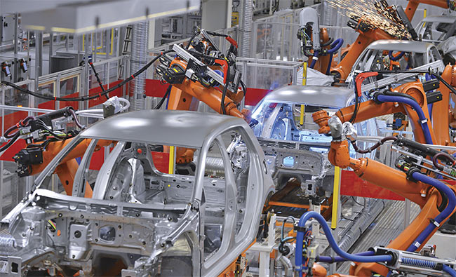 Robots welding in an automobile factory. Machine vision is used to detect pore sizes and the weld joint defects in automobile chassis. Courtesy of Stock.com/microolga.