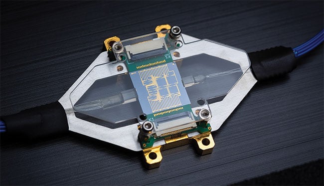 A PIC characterization package in which the north and south edges are allocated to electrical connections and the east and west edges are allocated to optical components. Adhering to a standard allocation such as this allows the packaging foundry to develop standardized housings, PCBs, and assembly processes. Courtesy of PHIX Photonics.