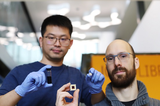From left: ICFO researcher Yongjie Wang and Qurv researcher Julien Schreier are shown holding a sample of a solution of quantum dots, the SWIR photodetector, and the image sensor. Courtesy of ICFO.