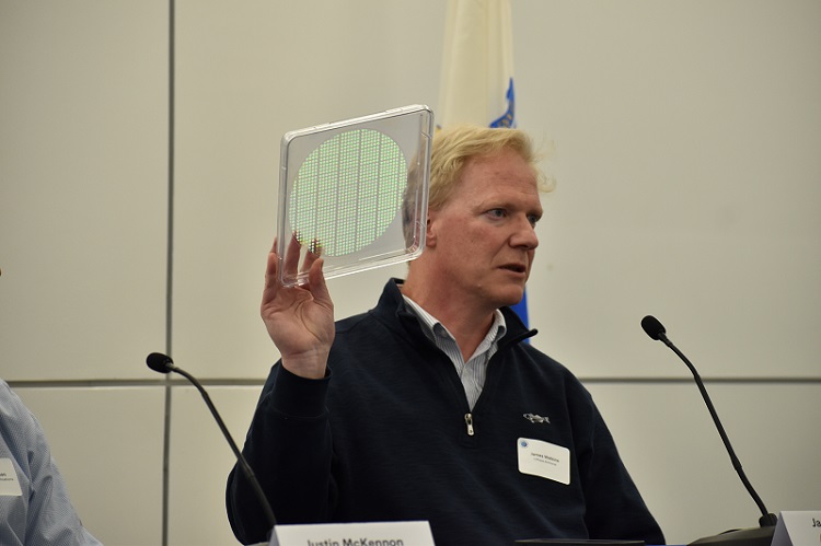UMass Amherst professor James Watkins holds up a wafer containing a thousand metalenses. Courtesy of Joel Williams/Photonics Media.
