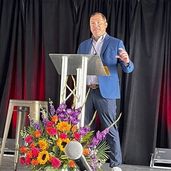 UbiQD CEO Hunter McDaniel on stage at a NMAEA event in Albuquerque, N.M. Courtesy of UbiQD.