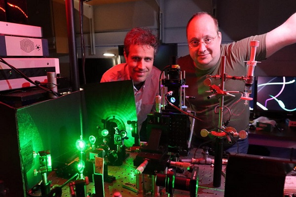 Professor Eric Potma (left) and professor Dmitry Fishman made a breakthrough discovery regarding the way light interacts with solid matter in silicon. Their work could lead to improved efficiency in solar electric systems, semiconductor lasers, and other advanced optoelectronic technologies. Courtesy of Lucas Van Wyk Joel/UC Irvine.