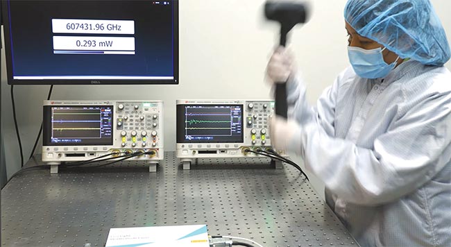 The commercial manufacture of visible lasers prioritizes ruggedization, among other qualities. One test involves pounding a table with a hammer (top) to ensure that the source stays in lock — indicating that it will maintain performance regardless of temperature or vibration extremes (bottom). Courtesy of Leonardo DRS Daylight Solutions.