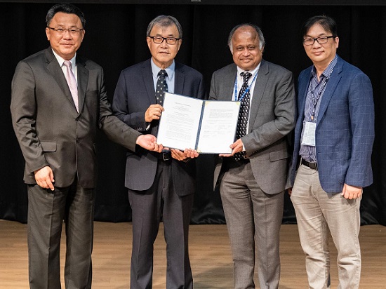 (From left) I-Yu Huang, dean of the College of Semiconductor and Advanced Technology Research at NSYSU; Ying-Yao Cheng, president of NSYSU and minister of education in Taiwan; Madhavan Swaminathan, head of electrical engineering at Penn State; and Shiao-Wei Kuo, dean of the NSYSU College of Engineering. Courtesy of Madhavan Swaminathan.