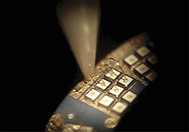 Packaging innovations improve LED capabilities. Wire bonding of the LED die in the chip-on-board manufacturing step connects it electrically to the package. Courtesy of ProPhotonix.
