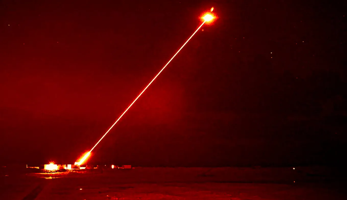 The U.K.’s DragonFire directed energy weapon, developed by MBDA, Qinetiq, and Leonardo, lights up the night as it targets a drone during a midnight interception. Courtesy of the Royal Navy.
