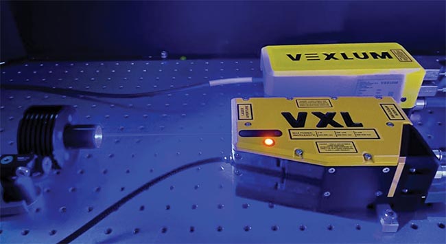 Figure 5. A compact vertical-external-cavity surface-emitting laser (VECSEL) designed to address the scaling needs of quantum computers and the environmental needs of quantum sensors (left). A reduction in size is due to the inherent advantages of a laser architecture that uses a minimalistic number of elements and simple cavity design. Broadly, VECSELs are an ideal platform to address the scaling needs of quantum systems. Courtesy of Vexlum Ltd.