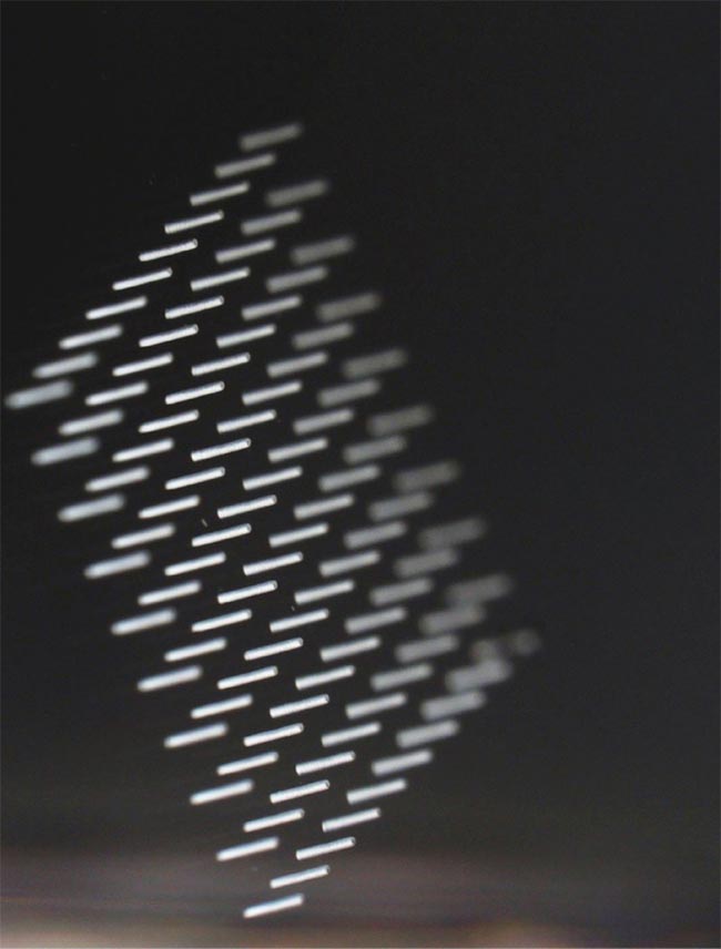 Through-glass vias (TGVs) fabricated in 1-mm-thick glass. The hole diameter is 65 µm, taper-free, and has an aspect ratio of 15:1. The use of the femtosecond source enables a single-step process that bypasses wet etching. Courtesy of Fluence.technology.